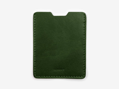 A slim, dark green leather cardholder with neat stitching along the edges and a notch at the top center, photographed against a plain white background.