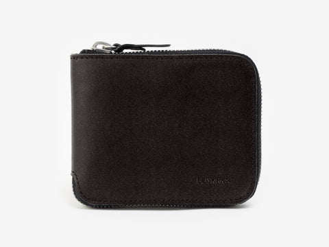 A black, square-shaped leather wallet with a zipper closure is photographed against a plain white background. The brand name is subtly embossed in the lower right corner.