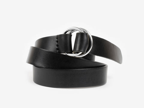A black leather belt with a shiny silver double-ring buckle, coiled neatly against a plain white background.