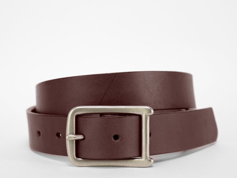 A coiled brown leather belt with a silver rectangular buckle, displayed against a plain white background.