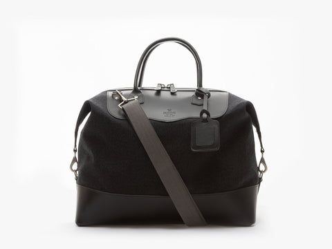Black Thornproof Carryall with a shoulder strap on a white background