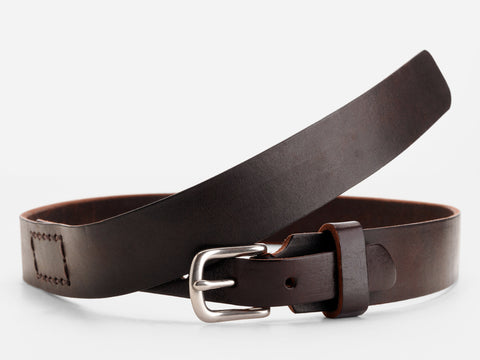 A dark brown leather belt with a silver buckle, coiled in a loose loop on a white background. The belt features visible stitching near the end.