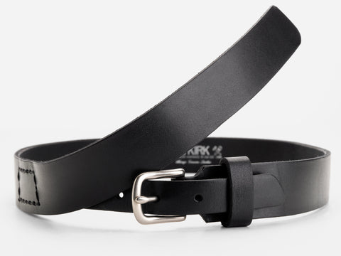 A black leather belt with a silver buckle is curled in a loose loop on a plain white background. The belt has stitched details near the end and a smooth, matte finish.