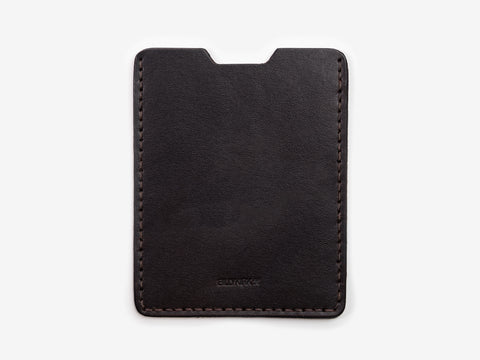 A minimalist, black leather card holder with visible stitching around the edges, displayed against a plain white background.