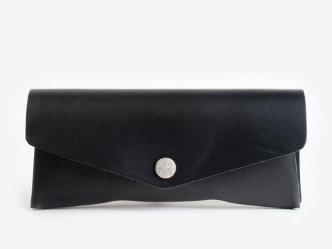 A black leather envelope-style clutch purse with a silver button clasp, displayed against a plain white background.