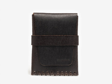 A minimalist, dark brown leather wallet with visible stitching at the bottom and a horizontal strap across the front, set against a plain white background.