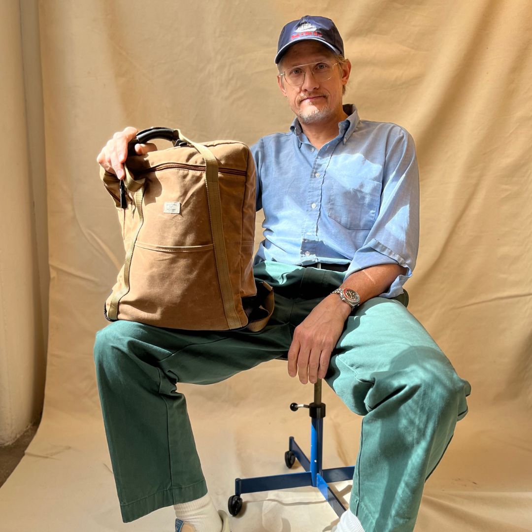 Man posing with No. 609 Backpack Tote in Brush Brown