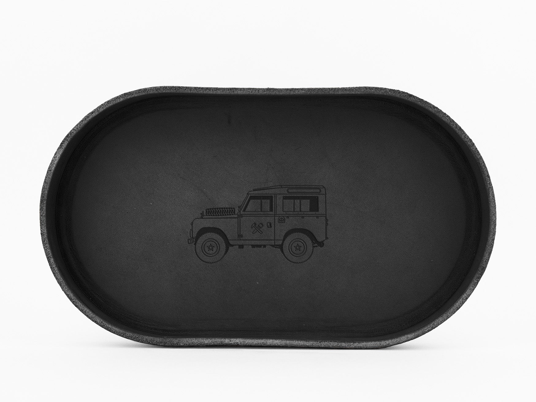 A black oval tray with a simple outline drawing of a classic off-road vehicle in the center, shown from a top-down perspective on a white background.