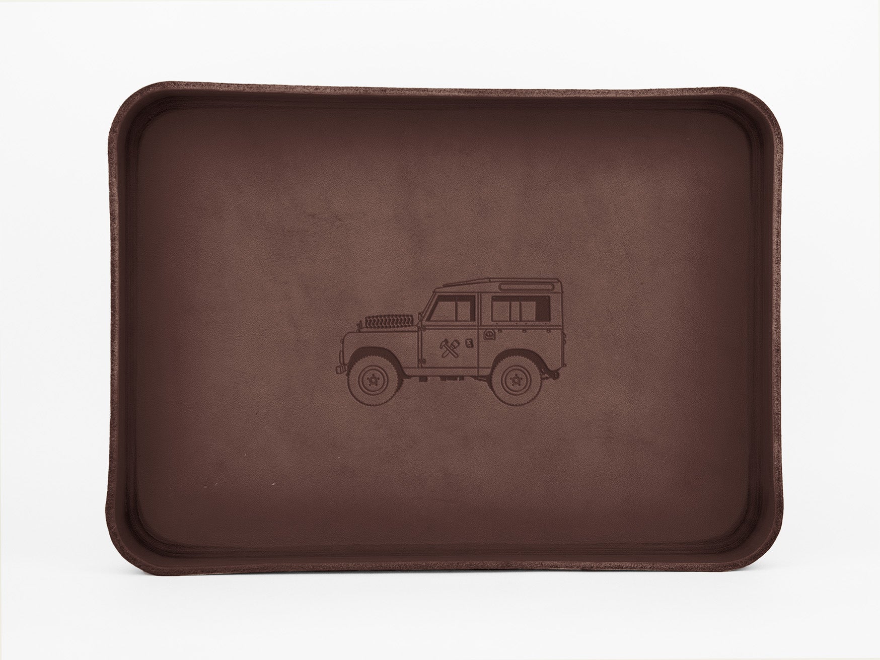 A brown rectangular tray with raised edges, featuring a simple line drawing of a classic off-road vehicle in the center.