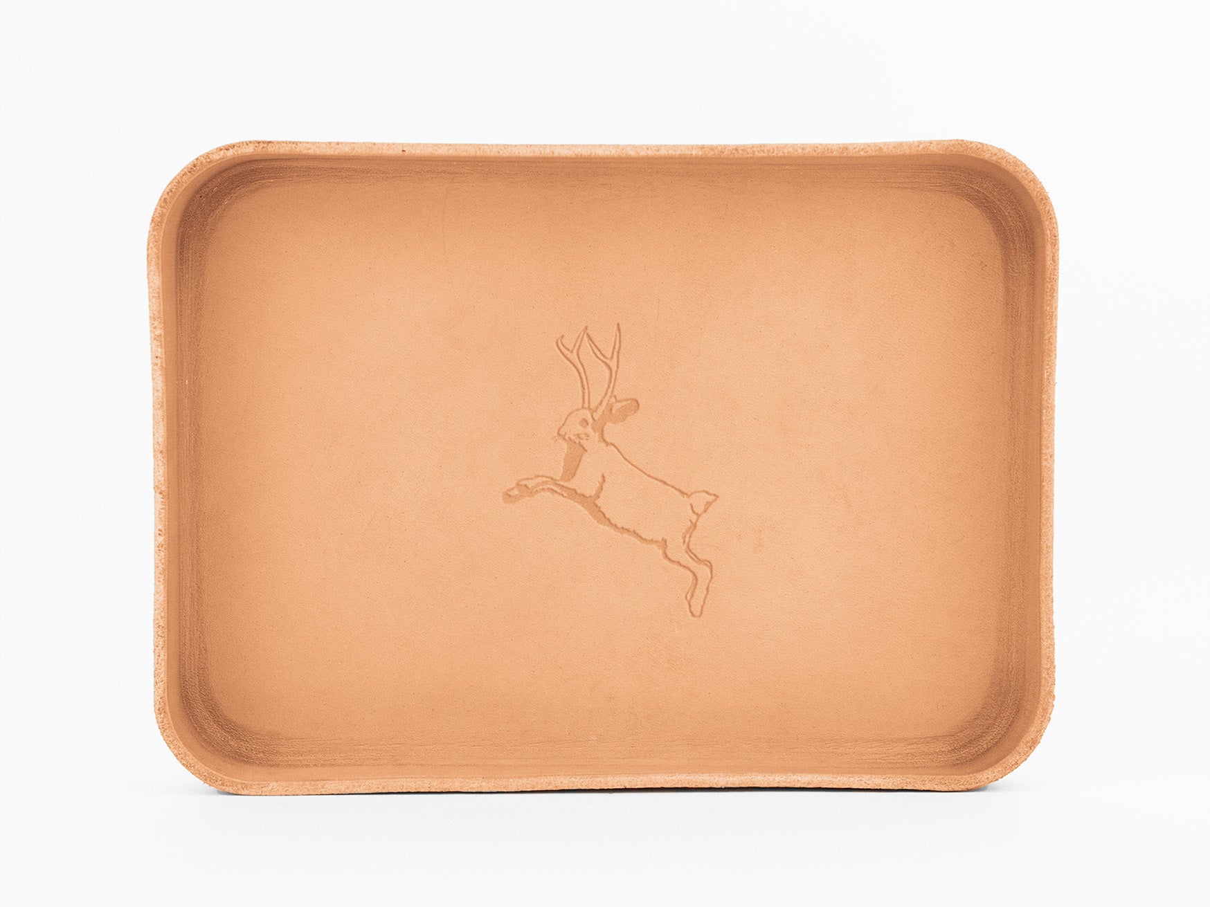 A rectangular tan leather tray with rounded corners, featuring an engraved illustration of a jackalope (a jackrabbit with antelope horns) in the center.