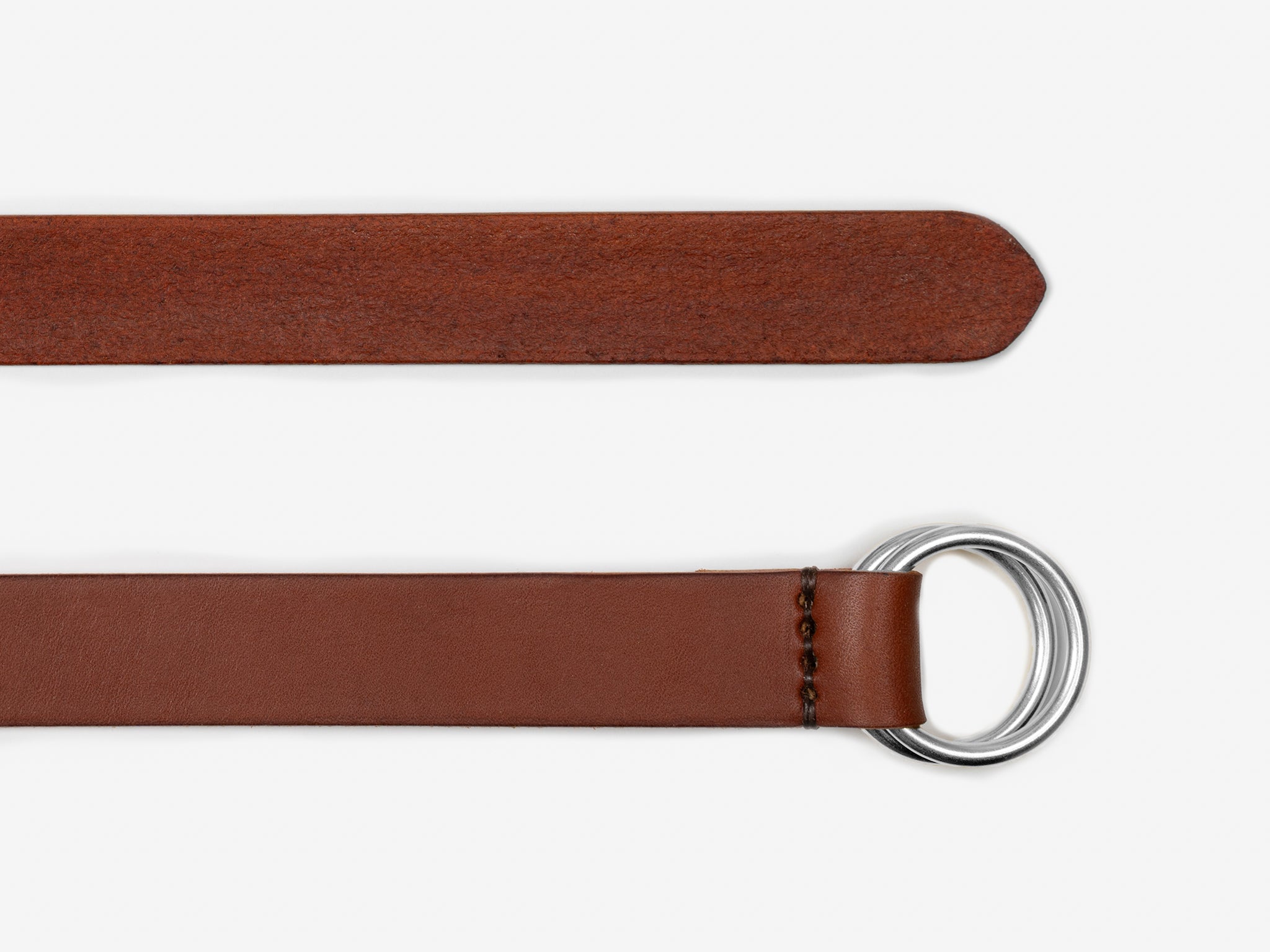 A brown leather belt with a pointed end and a double metal ring buckle, shown laid flat on a white background.