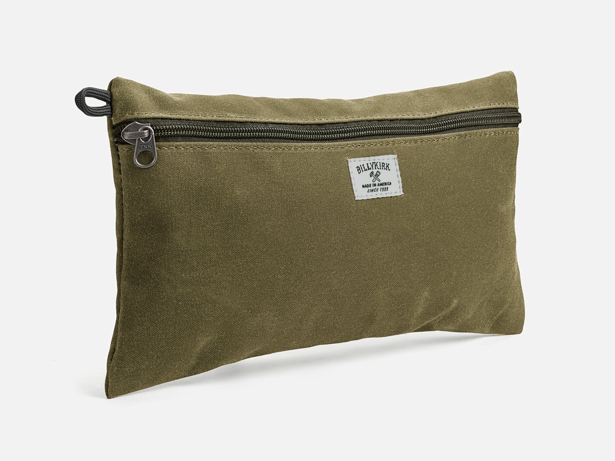 An olive waxed canvas pouch with zipper closure on a neutral background. It features a cream woven tag that reads "Billykirk made in america since 1999".