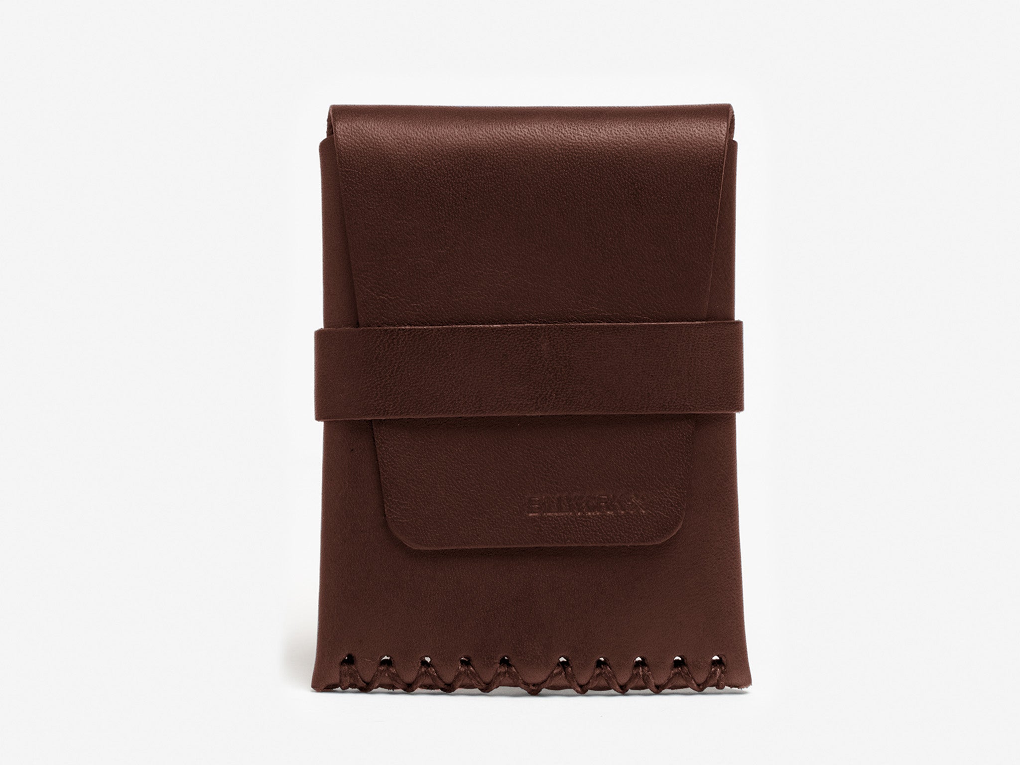 A brown leather wallet with a folded flap secured by a wide strap and decorative stitching along the bottom edge, displayed against a plain white background.