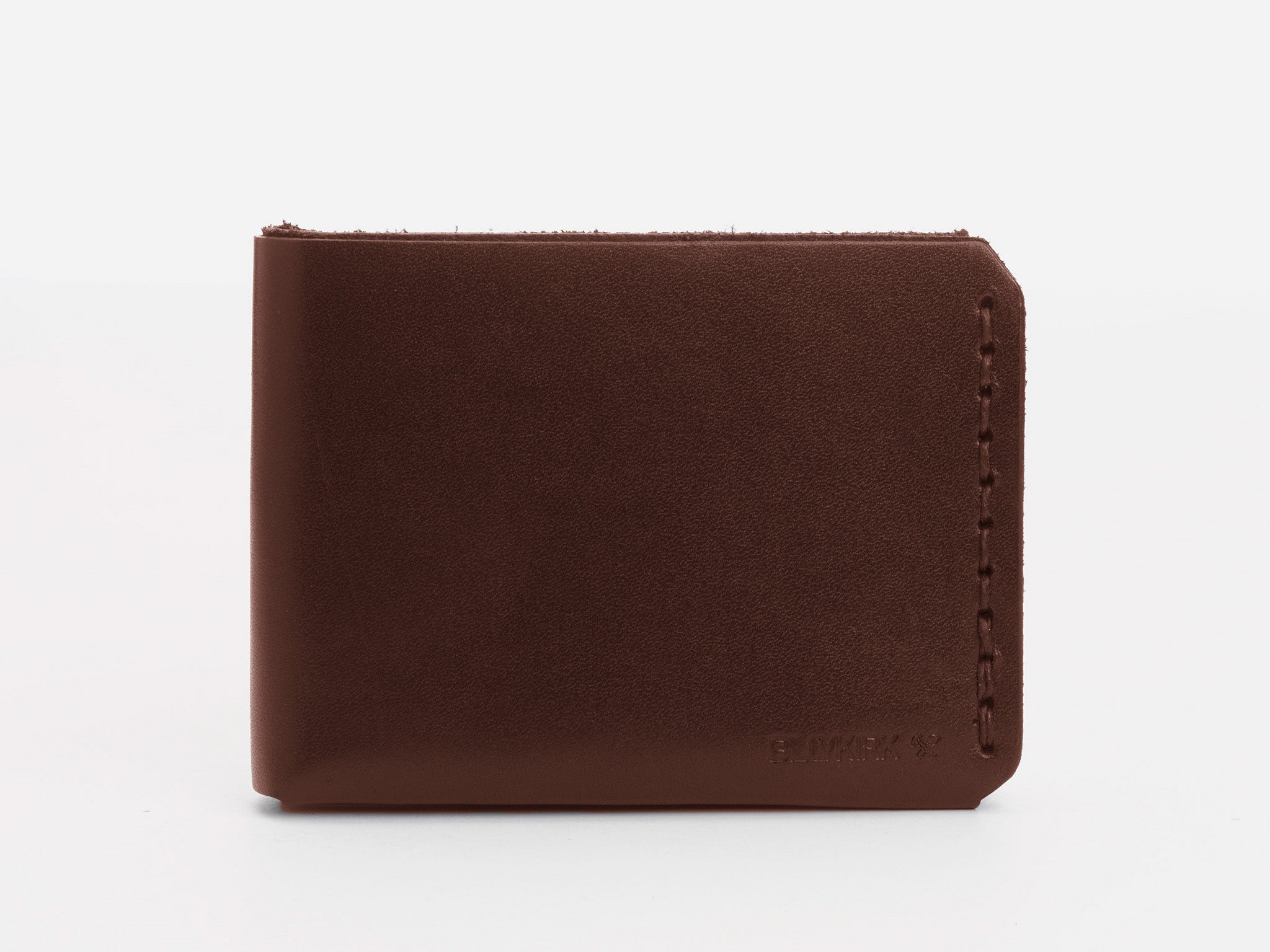 A closed brown leather wallet is displayed upright against a plain white background, showing its simple design and neat stitching along the right edge.