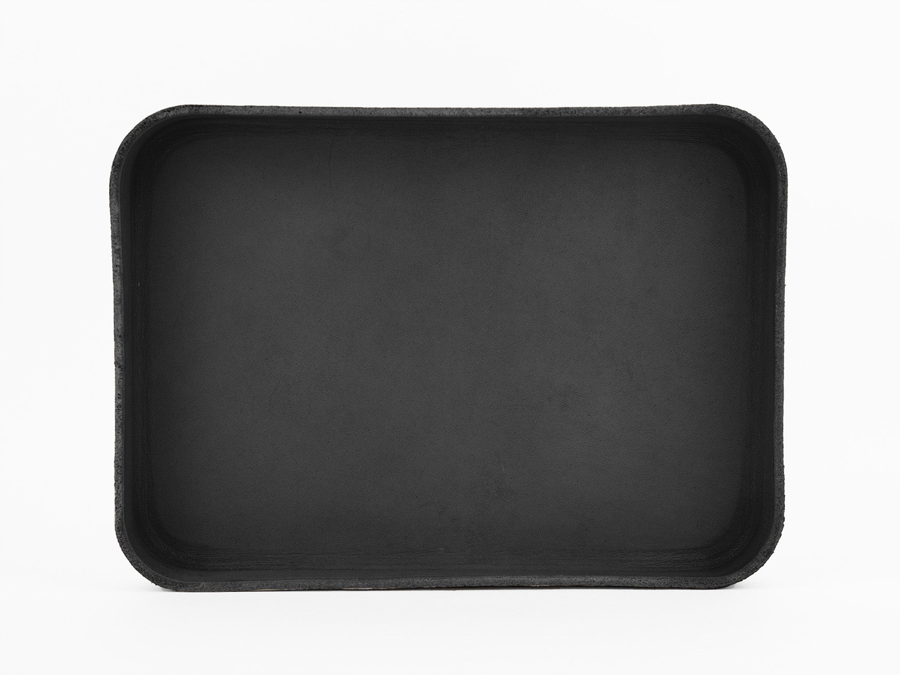 A rectangular, black, shallow tray with rounded corners is centered on a plain white background. The tray is empty and has a smooth, matte finish.