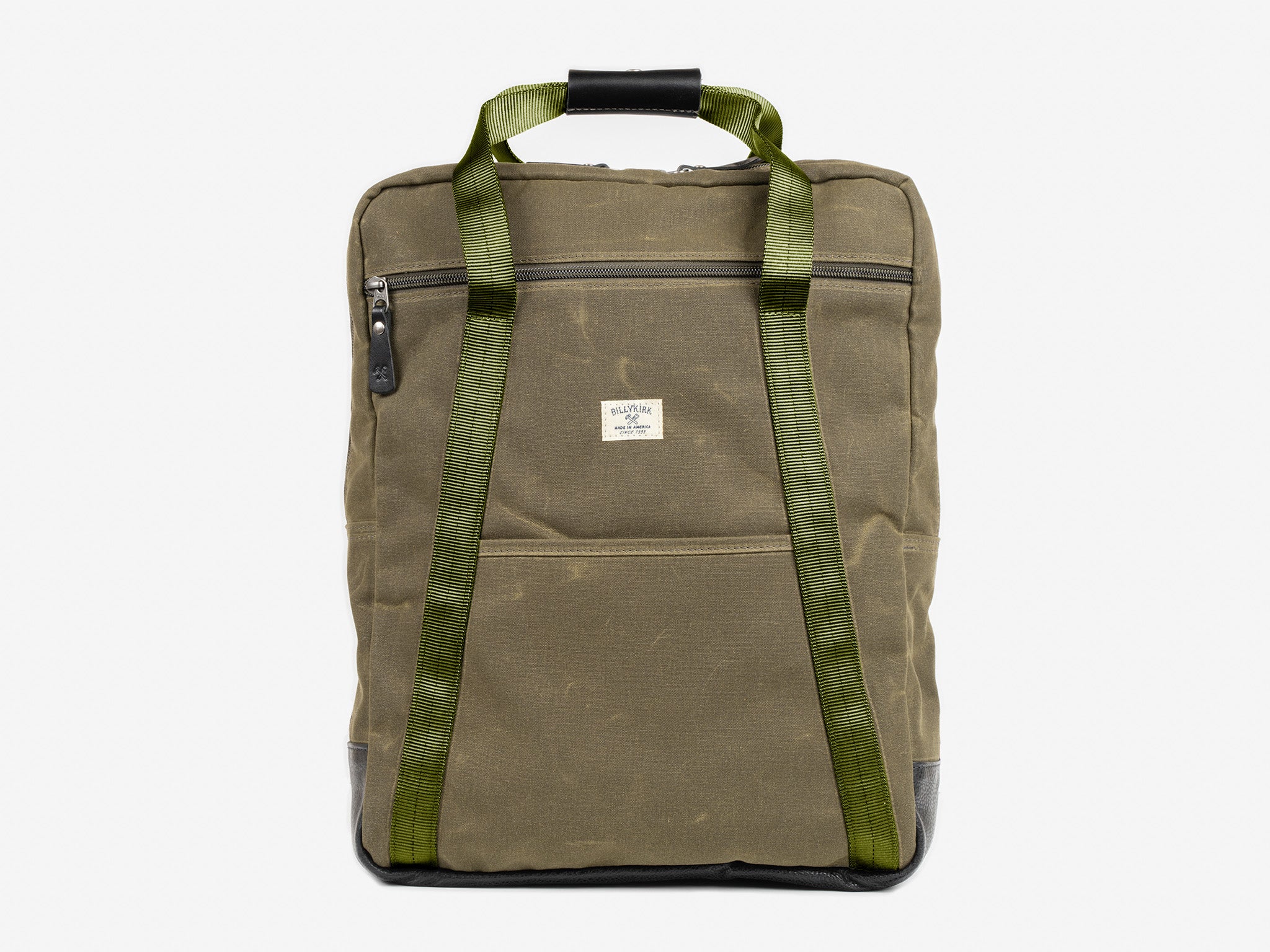 Olive waxed canvas backpack tote with zipper front pocket and olive nylon straps. The bag is shown front on with a white background.