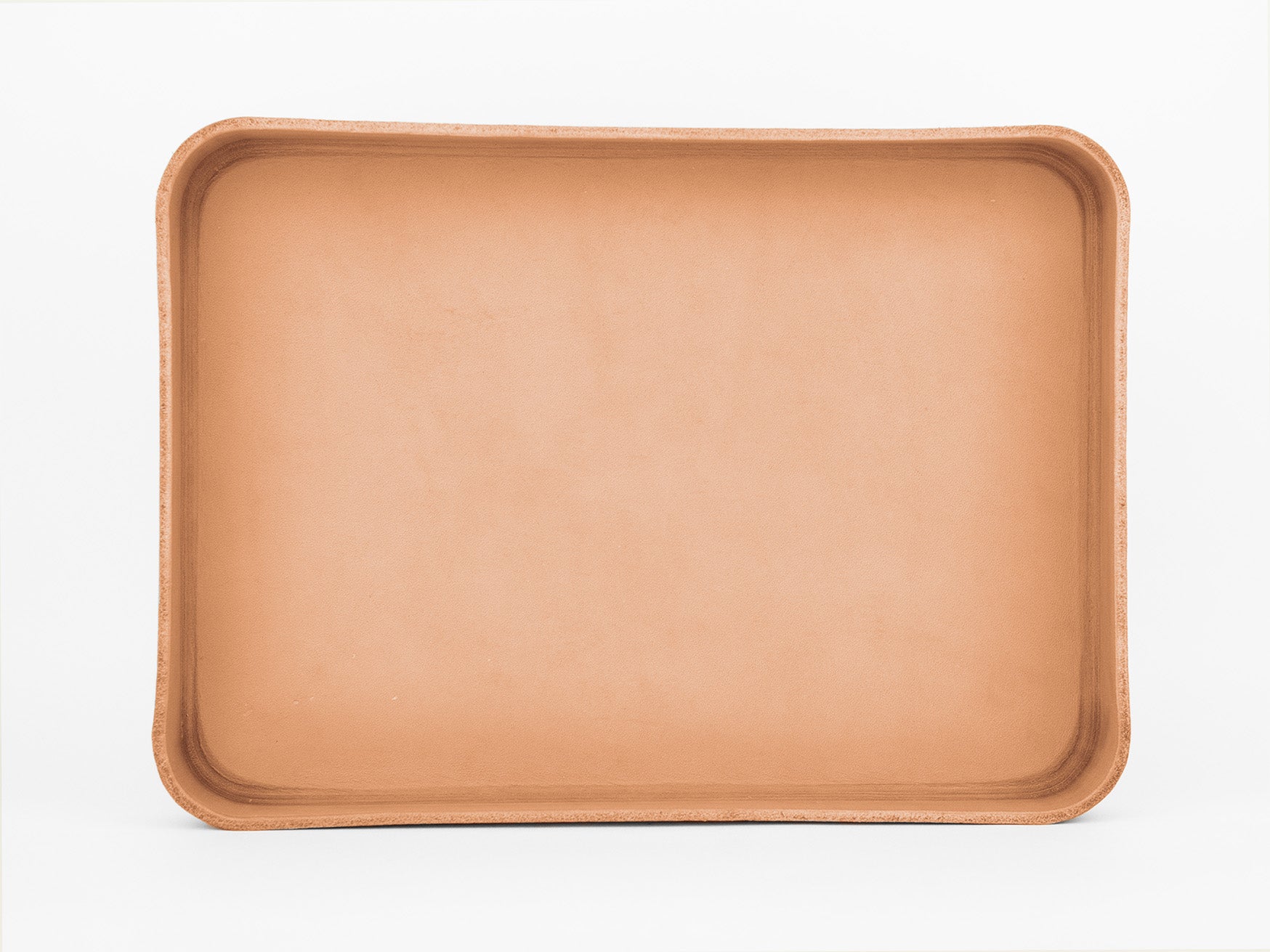A rectangular, shallow, tan clay tray with rounded corners, set against a plain white background.