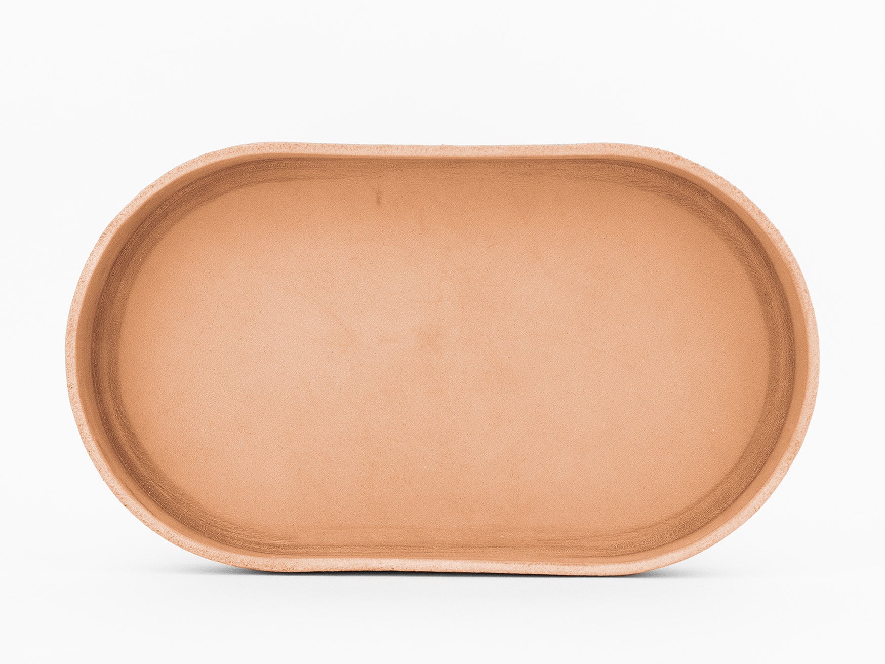 A plain, oval-shaped, natural colored  tray is shown from above against a white background.