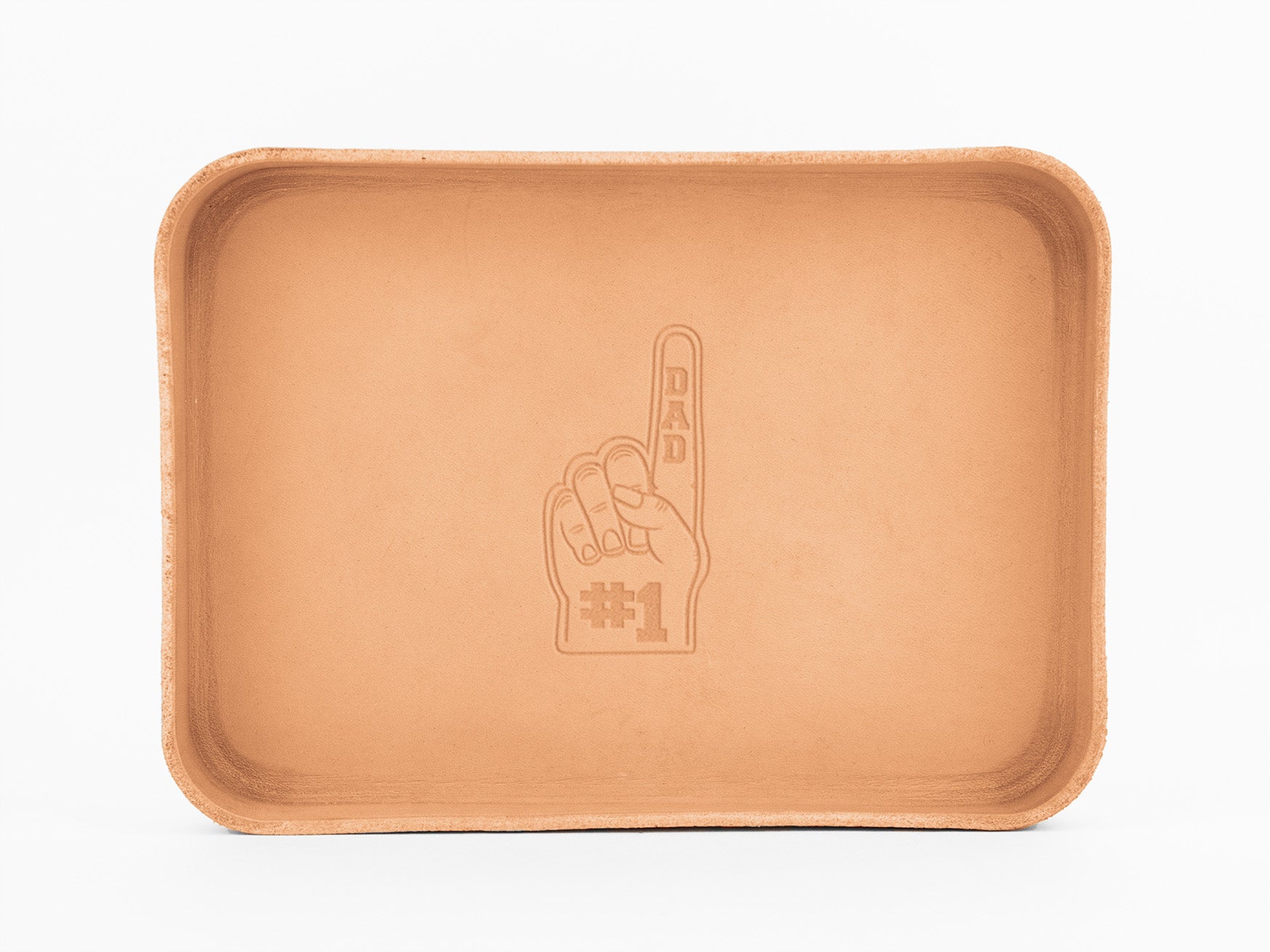 A rectangular, light brown leather tray with rounded edges features an embossed foam finger graphic in the center, labeled DAD #1. The background is plain white.