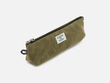 An olive waxed canvas pouch with zipper closure on a neutral background. It features a cream woven tag that reads "Billykirk made in america since 1999".