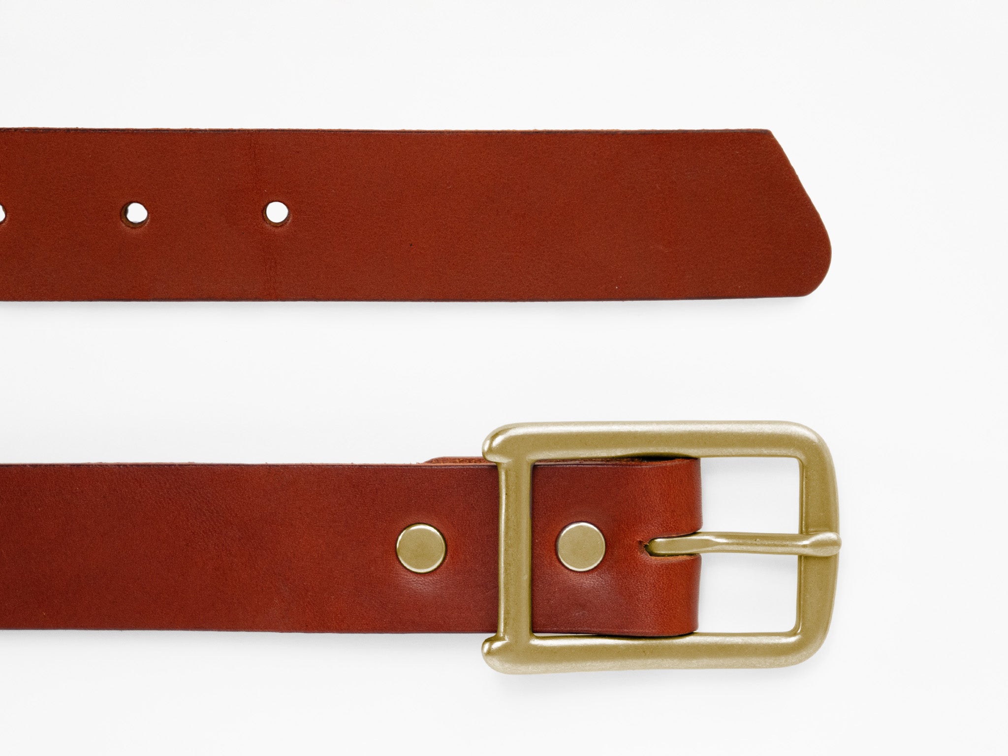 A brown leather belt with a gold buckle is laid flat on a white background. The belt has several holes and metal rivets near the buckle.