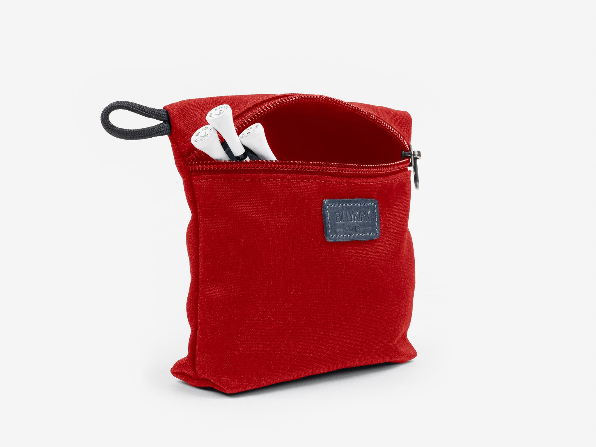 A small red zippered pouch with a black loop, partially open to reveal two white markers inside. A rectangular black label is sewn onto the front of the pouch.