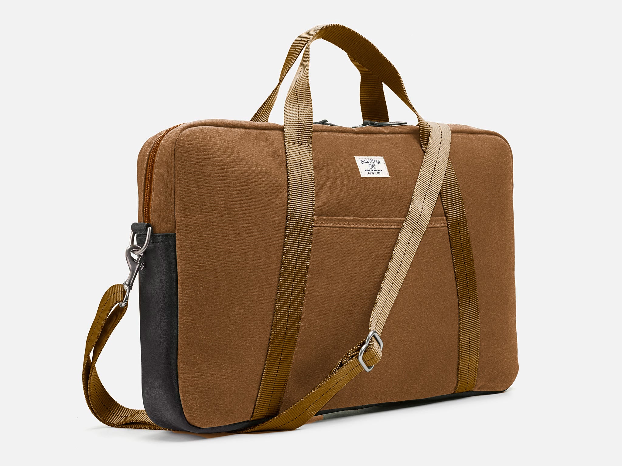 Brush Brown waxed canvas laptop briefcase bag with tan shoulder straps, a small front pocket, and a black leather bottom detail against a plain background.
