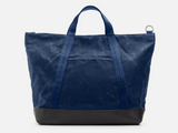 Blue tote bag with black base on a white background