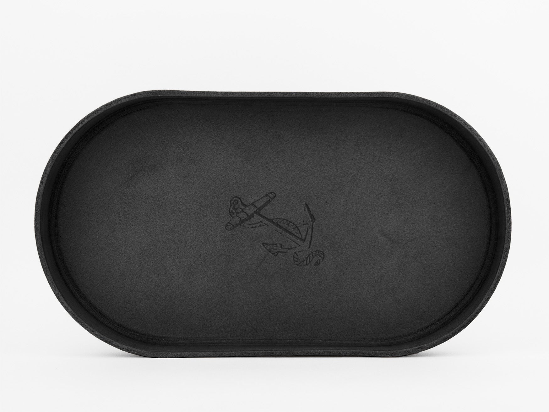 A black, oval-shaped tray with raised edges, featuring an anchor design etched in the center, set against a plain white background.