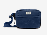 Blue shoulder bag with a visible brand label on a white background
