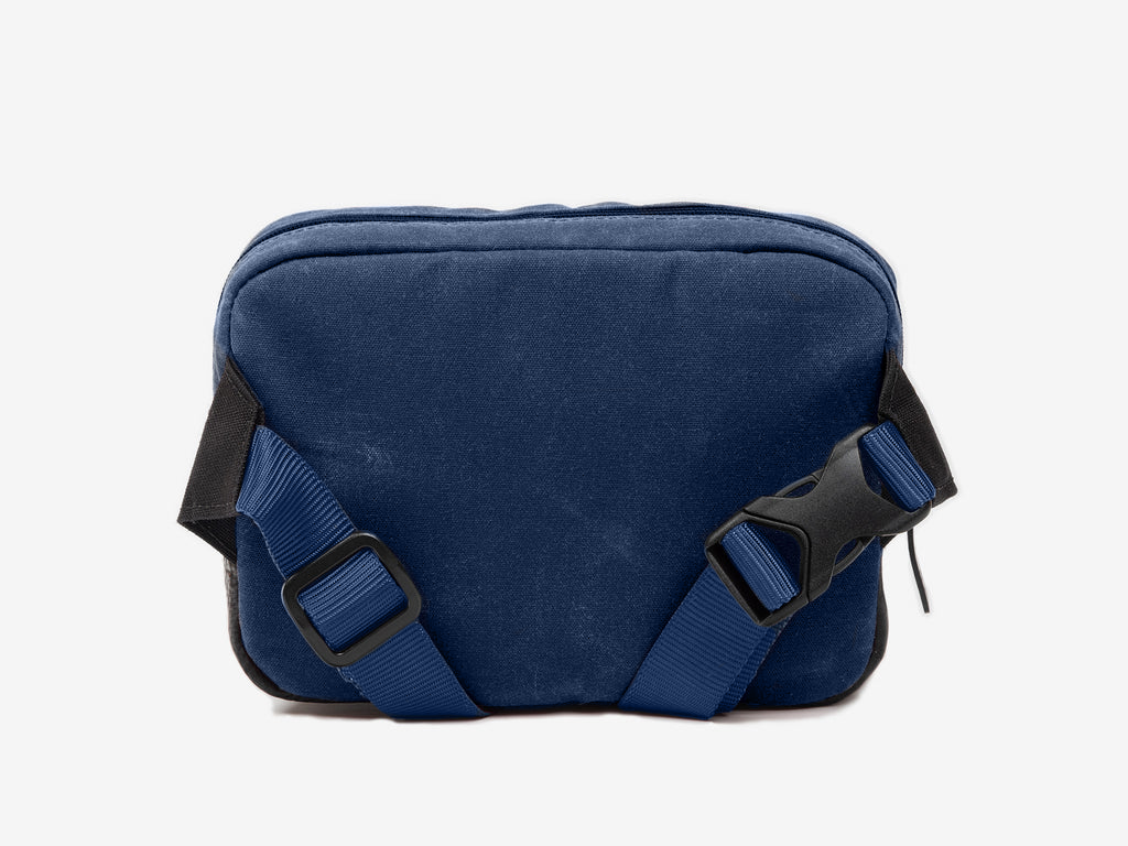 Blue shoulder bag with black straps on a white background