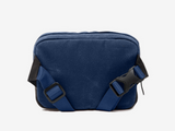 Blue shoulder bag with black straps on a white background