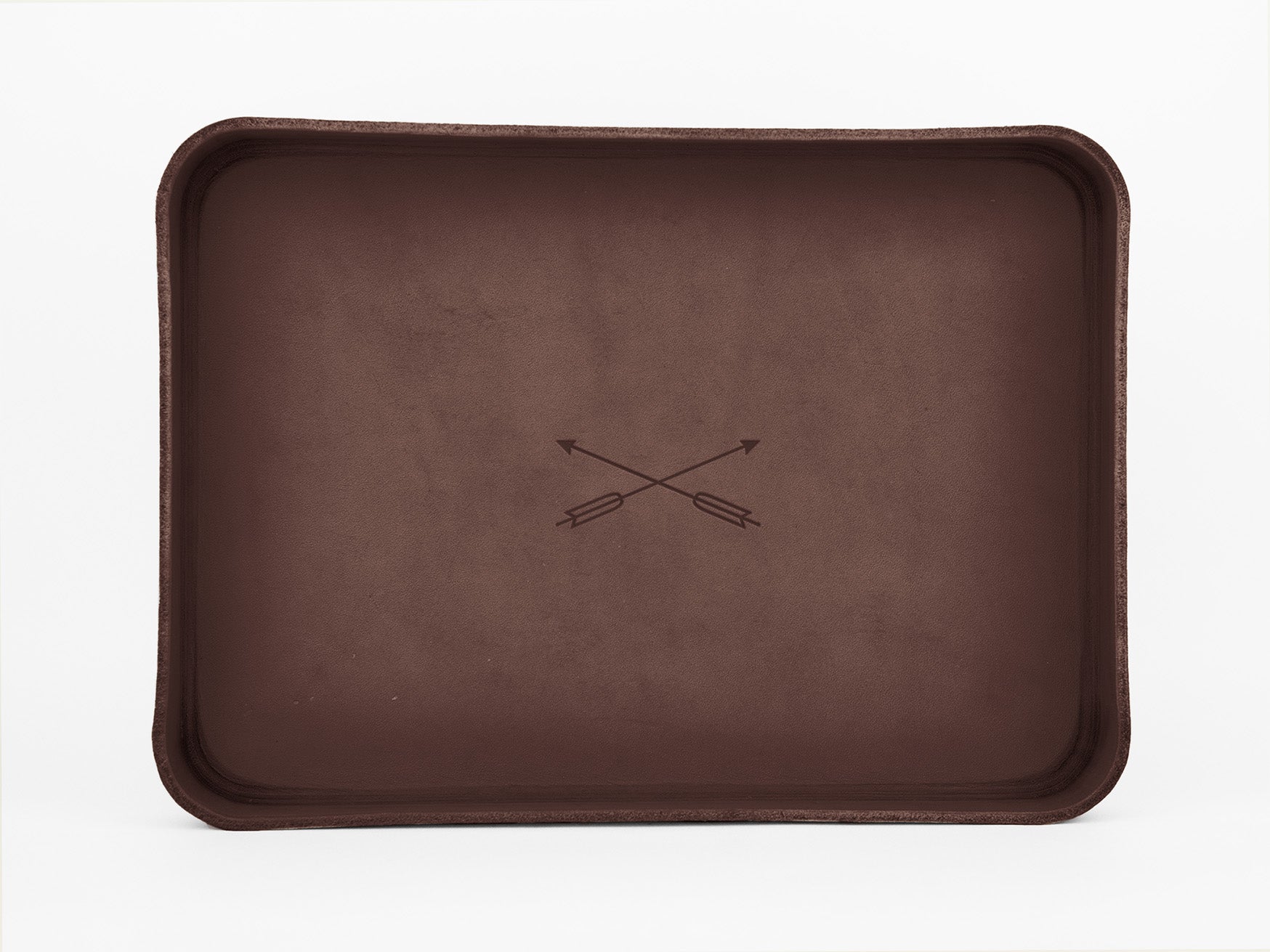 A rectangular brown tray with rounded edges and a minimalist design featuring two crossed arrows in the center, placed on a white background.