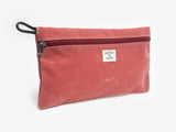 A nantucket red canvas pouch with zipper closure on a neutral background. It features a cream woven tag that reads "Billykirk made in america since 1999".