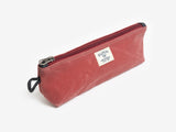 A nantucket red canvas pouch with zipper closure on a neutral background. It features a cream woven tag that reads "Billykirk made in america since 1999".