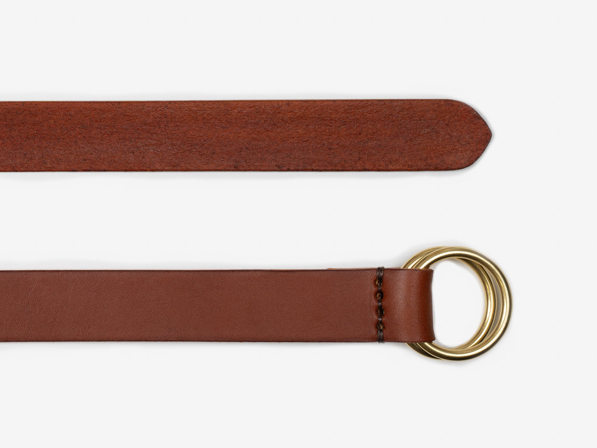 A brown leather belt with a pointed tip and a double gold D-ring buckle, shown laid flat on a white background.