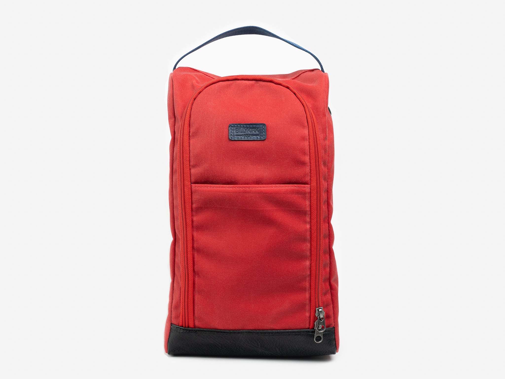 A red fabric shoe bag with a black handle on top, a front zipper pocket, and a black base, displayed against a plain light background.