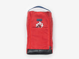 A red fabric shoe bag with a black handle on top, a front zipper pocket, a front flap with six white tees, and a black base, displayed against a plain light background.