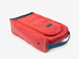 A red rectangular fabric shoe bag with a zipper, a front pocket, and a blue carrying handle, displayed on a white background.