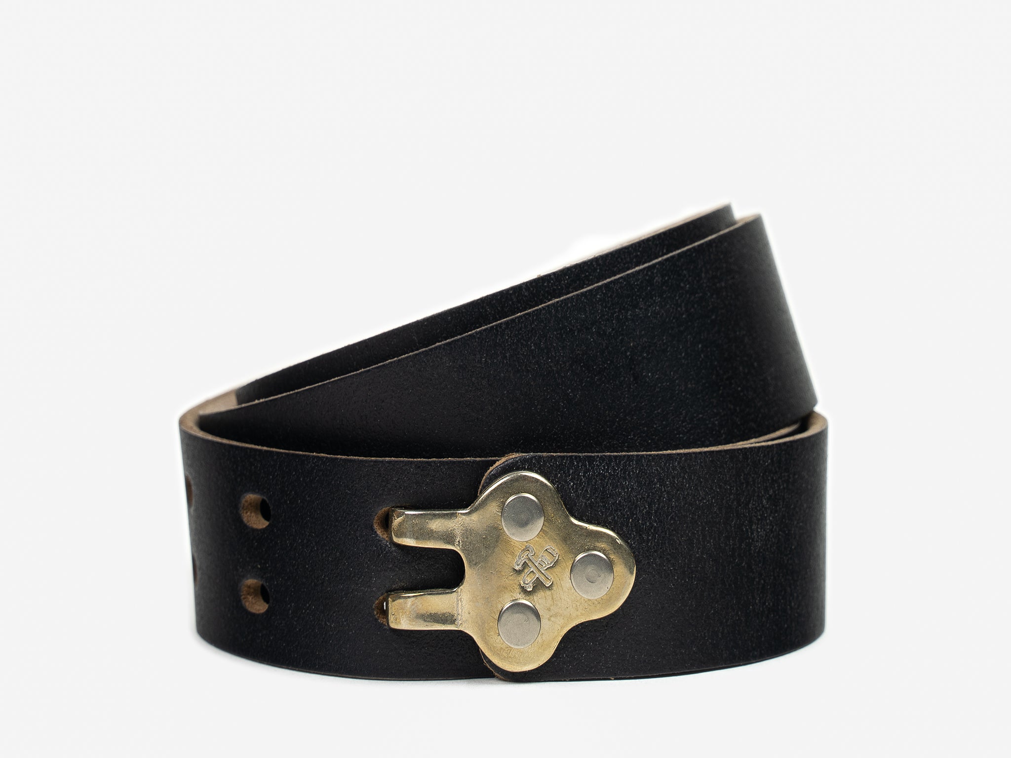 A black leather belt with a unique brass buckle shaped like a vintage keyhole, partially coiled on a white background.