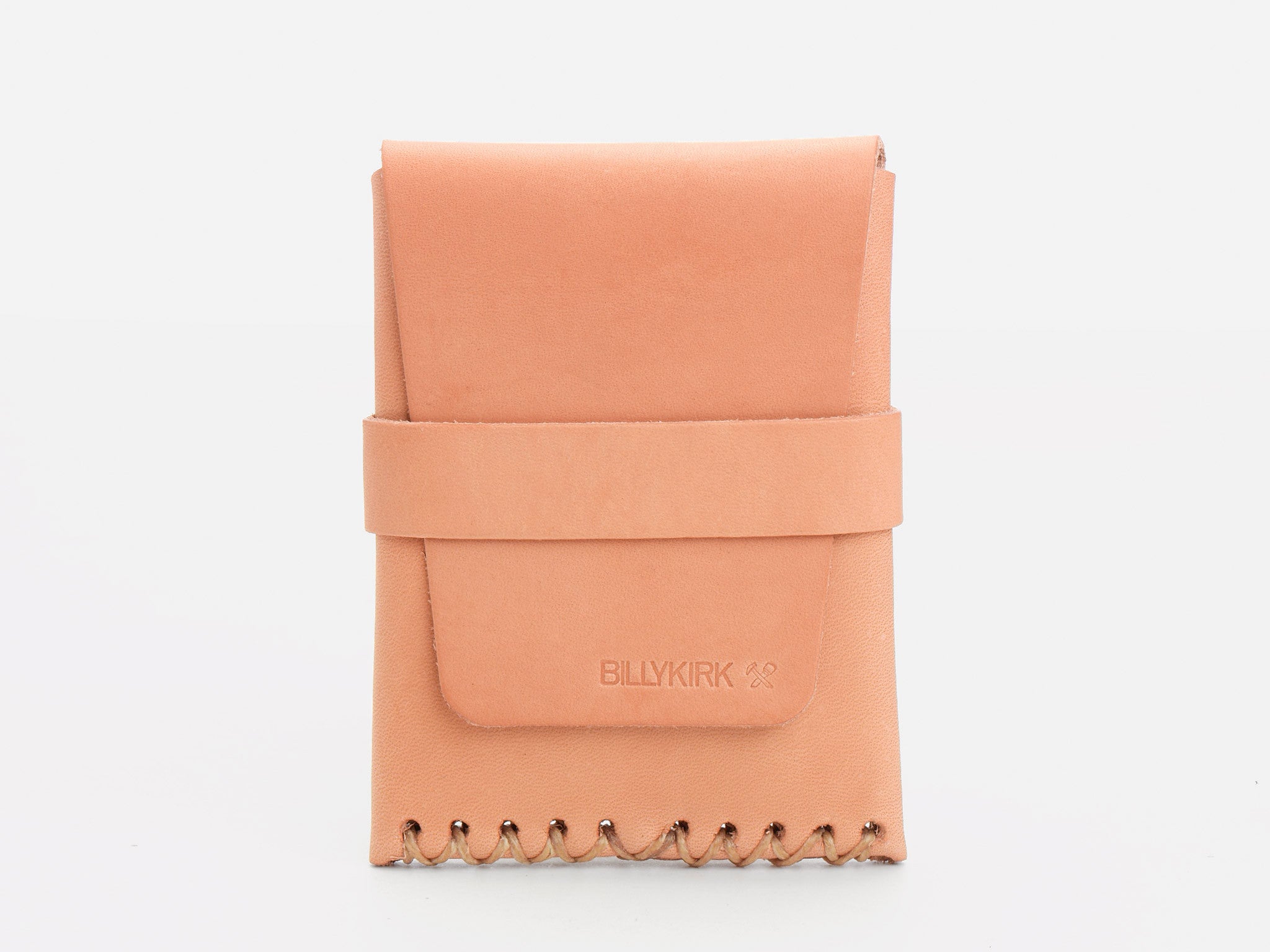 A natural colored leather card case with a flap closure, wide strap across the front, and decorative stitching along the bottom edge, placed against a plain white background.
