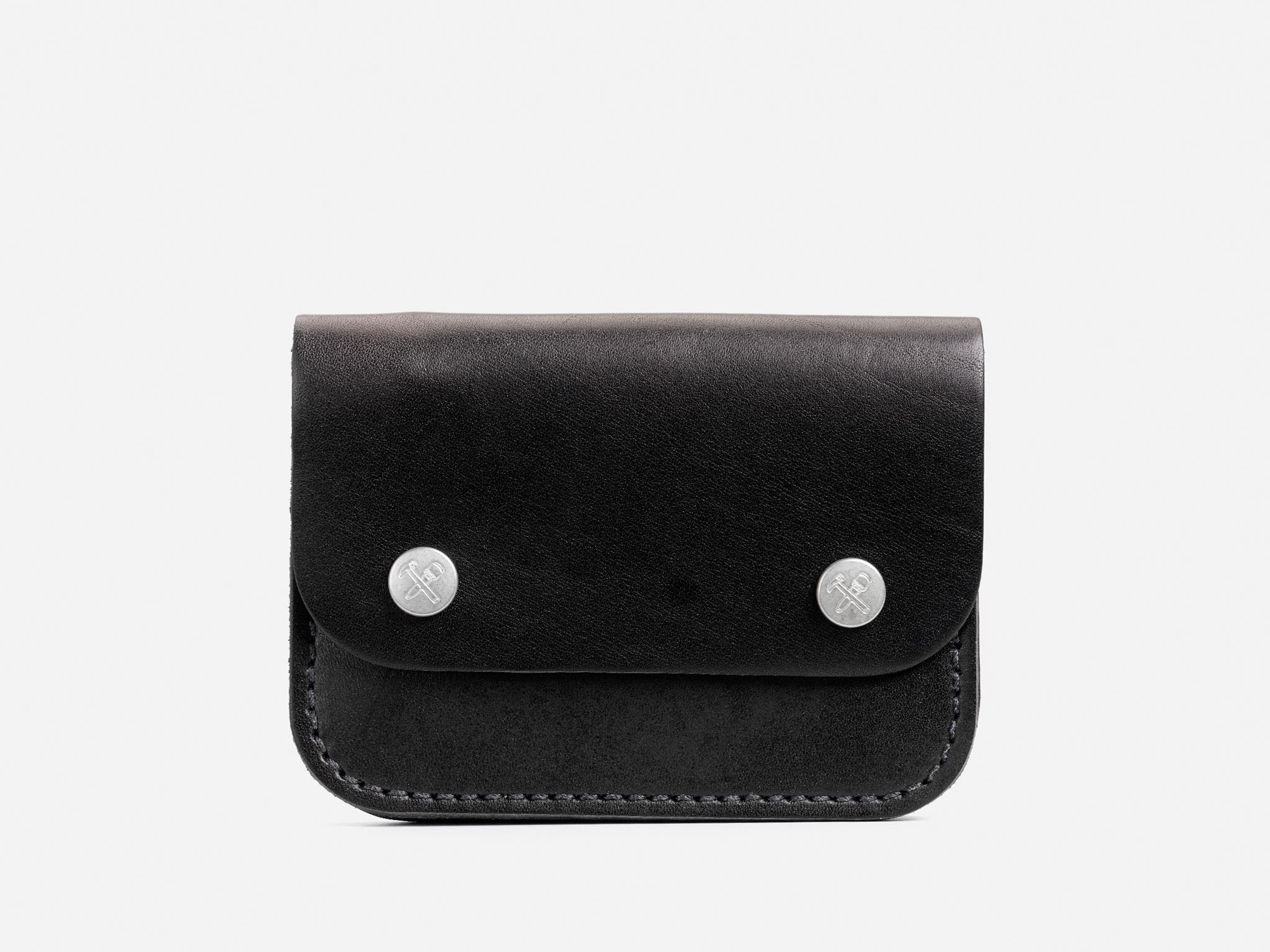 A small black leather wallet with rounded corners, a flap closure, and two silver snap buttons on the front, photographed against a plain white background.