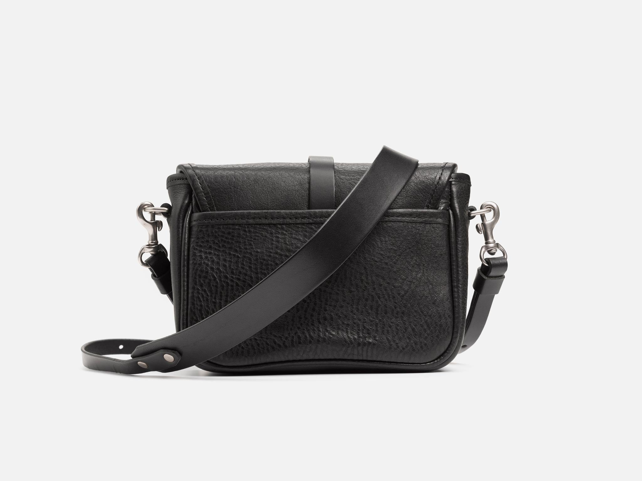 A small black leather crossbody bag with a long adjustable strap, metal clasps, and a front flap pocket, displayed against a plain white background.