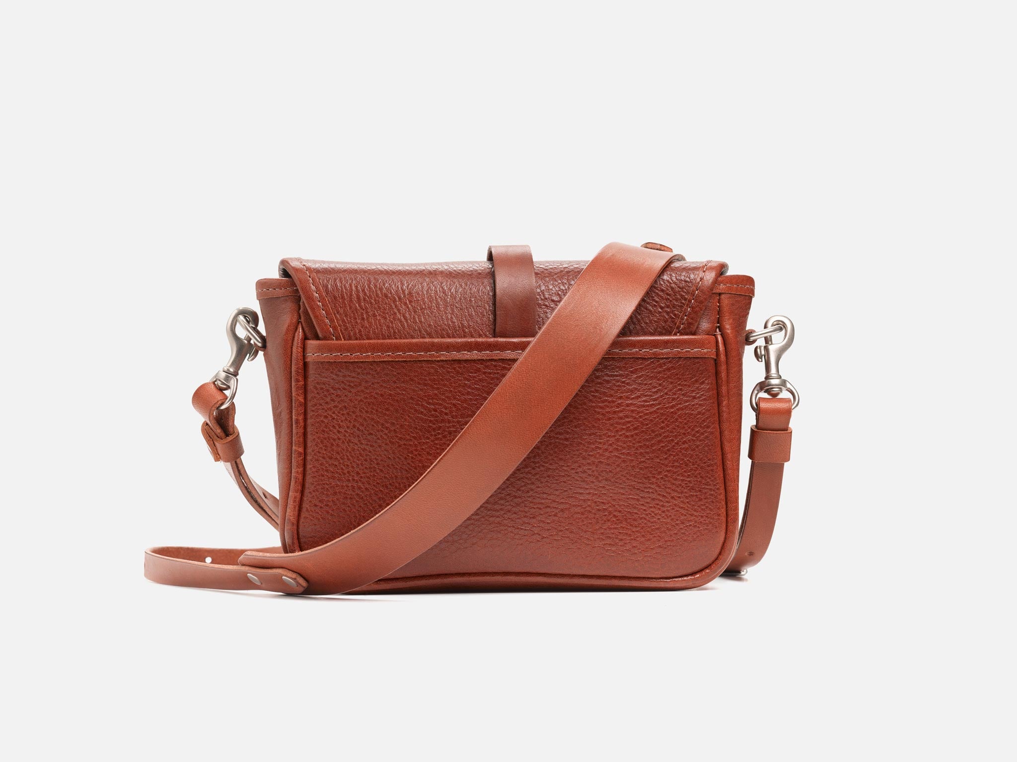 A small brown leather crossbody bag with a front pocket and adjustable strap, shown against a plain white background.