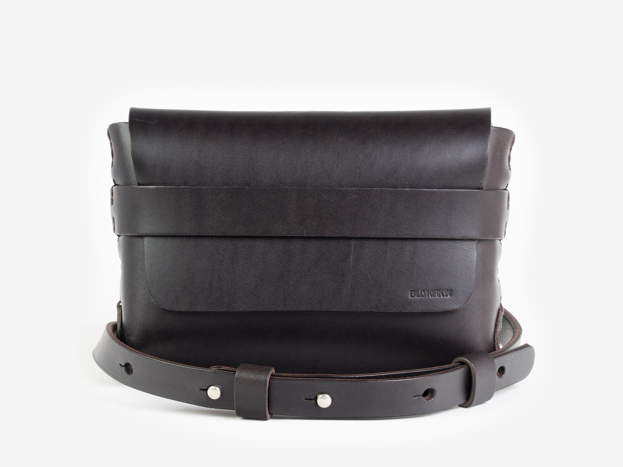 A dark brown leather belt crossbody bag with a smooth finish, featuring a flap closure, subtle embossed branding, and an adjustable strap with silver-tone collar buttons, displayed against a white background.
