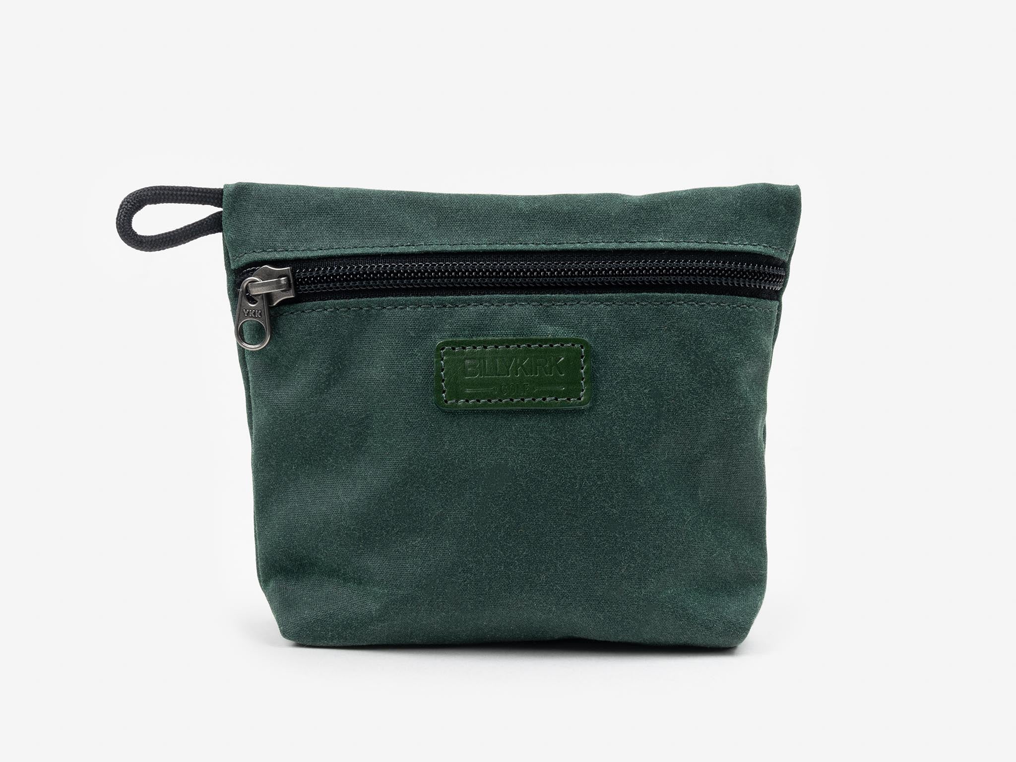 A small, dark green zippered pouch with a black zipper at the top and a stitched rectangular patch on the front, set against a plain white background.