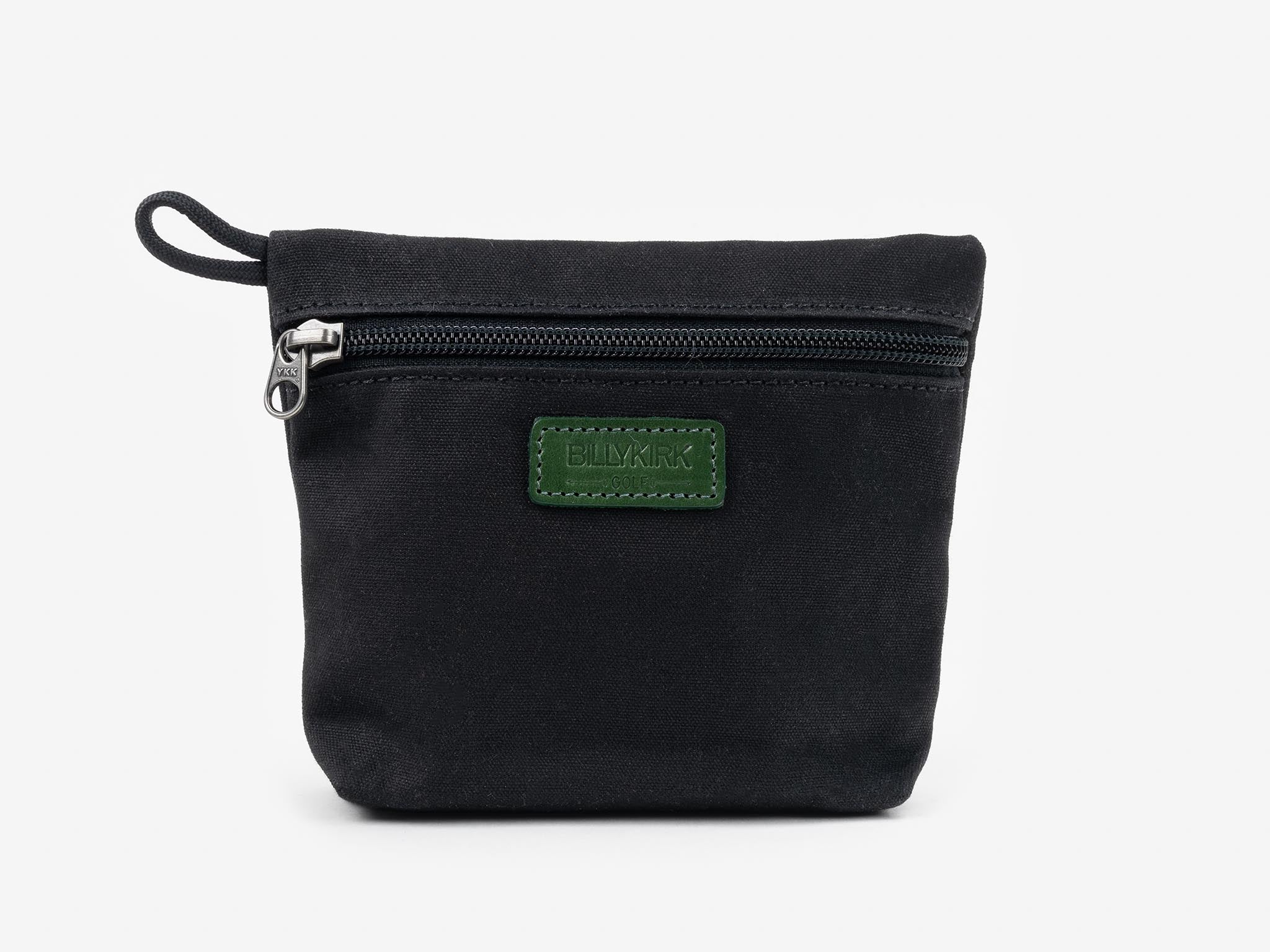 A small black fabric pouch with a zipper on the front and a green rectangular patch with the brand name BIMKRI stitched in the center. The pouch has a short fabric loop on the left side.