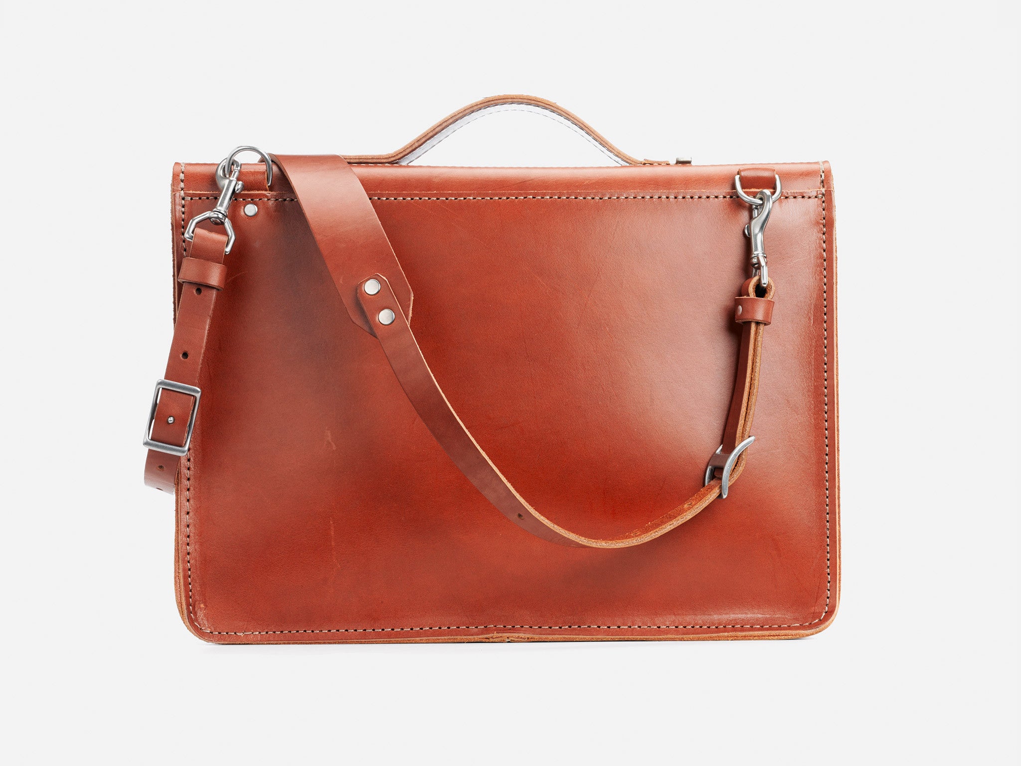 A brown leather briefcase with a shoulder strap, silver buckle, and handle, displayed against a plain white background. The briefcase has visible stitching along the edges.